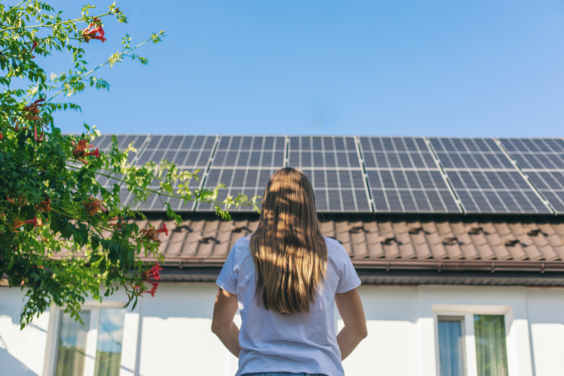 Homeowner viewing rooftop solar panels on a residential home