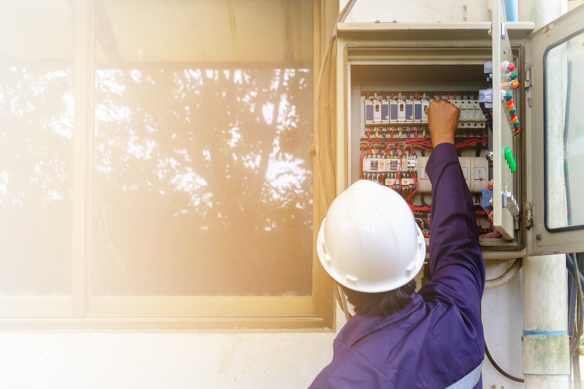 Licensed electrician working inside an electrical panel